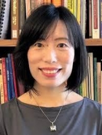 Headshot Of Dr. Jiajia Wang Standing In Front Of A Bookcase