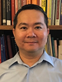 Headshot Of Dr. Chih-jen Melvin Lee Standing In Front Of A Bookcase