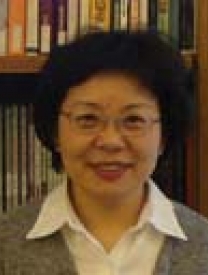 Headshot Of Dr. Mien-Hwa Chiang Standing In Front Of A Bookcase