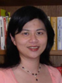 Headshot Of Ms. Grace Wu Standing In Front Of A Bookcase